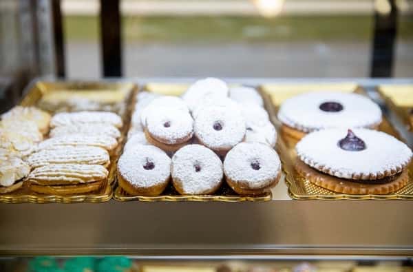 A varietion of different pastries covered in powdered sugar