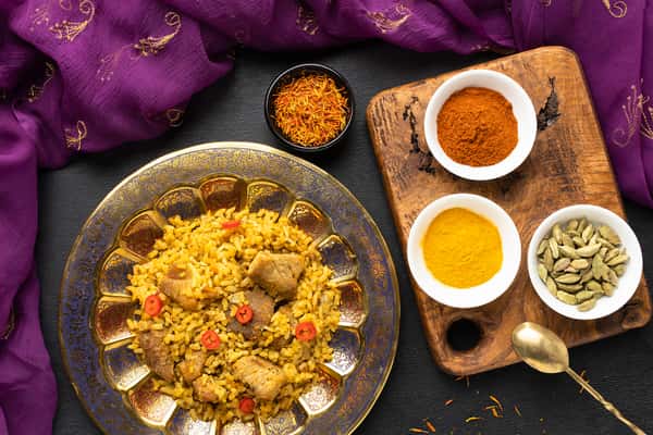 Overhead view of Indian rice dish with spices and sauces