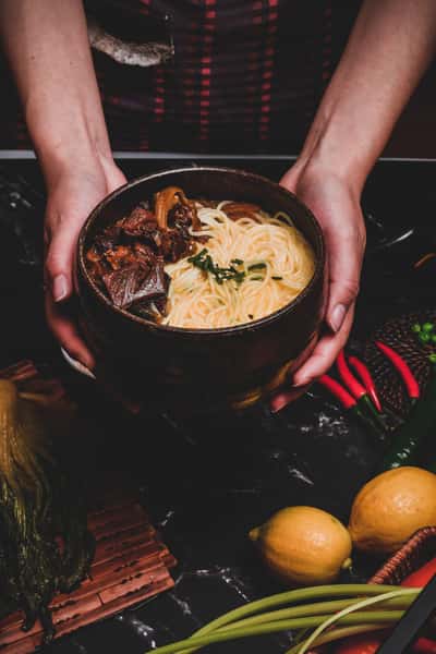 handing you a bowl of ramen