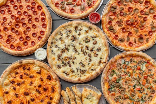 A table full of pizzas