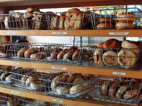 bakery display cabakery display case filled with assorted fresh bagels and breadsse filled with assorted fresh bagels and breads