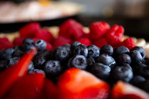 fresh mixed berries including strawberries and blueberries in a close-up view