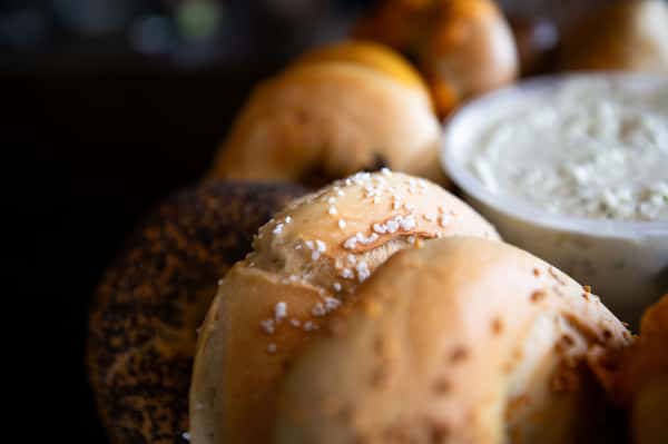 assorted bagels including sesame and everything bagels arranged on a tray