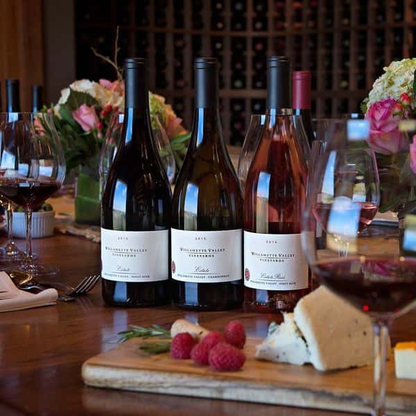bottles of wine with cheese tray