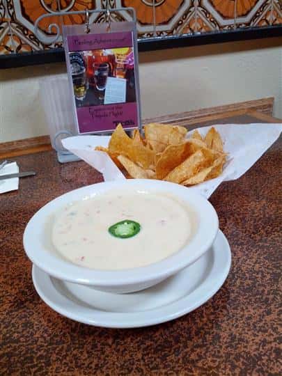spiced chips in a basket with dipping sauce