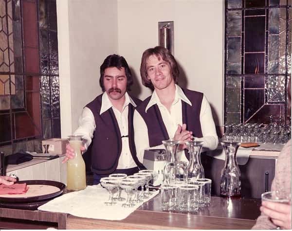 vintage image of two waiters smiling for the camera