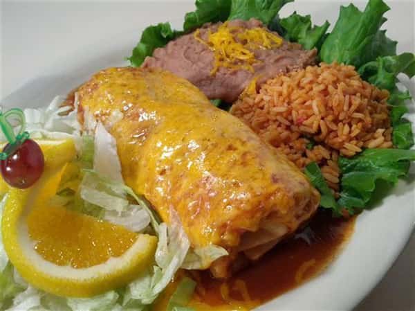 Chimichango with a side salad, rice and beans
