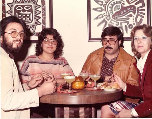 vintage image of a family eating at a table with drinks