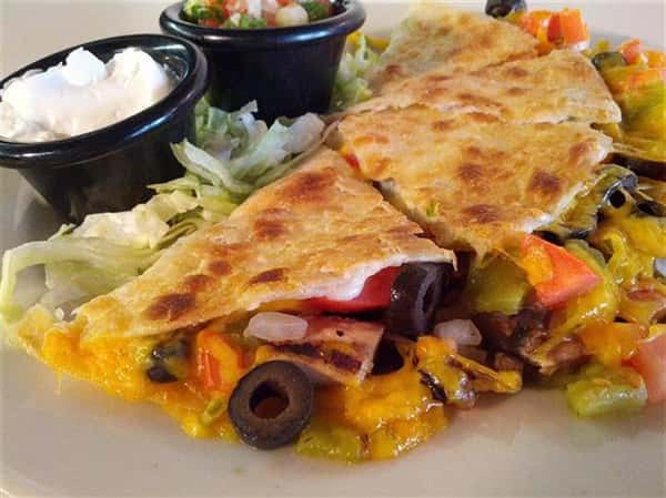 Quesadilla with cheese, olives, tomatoes and onions