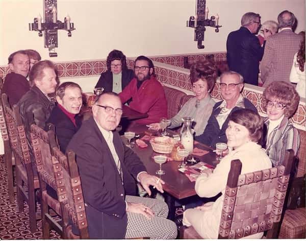 vintage image of a family eating at a table with drinks