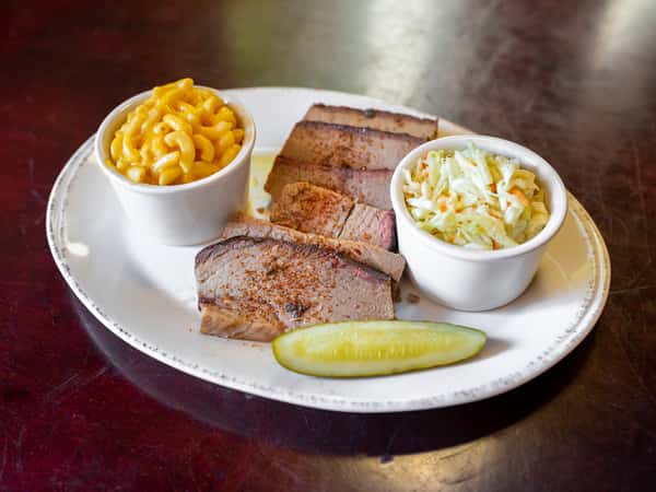 Beef Brisket Platter is one of the most-loved picks at Wholly Smokin' Downtown 🔥 Tender, satisfying, and served with your choice of 2 sides, it's the kind of plate guests come back for again and again. 🍽️ #WhollySmokinDowntown #BeefBrisketPlatter #BBQFavorites
