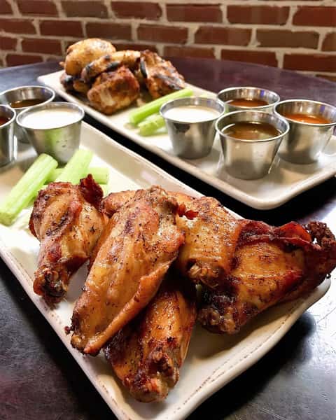 Smoked Chicken Wings are a top seller at Wholly Smokin' Downtown for good reason 🔥 Grilled or fried, served with celery, and your choice of up to 3 sauces—these crowd-pleasers keep guests coming back for more. 🍗 #WhollySmokinDowntown #SmokedChickenWings #BBQFavorites