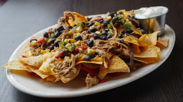 Dig into WS BBQ Nachos at Wholly Smokin' Downtown 😋 Choice of BBQ pork or pulled chicken piled over tortilla chips with roasted corn & black bean jalapeno salsa, beer cheese sauce, and sour cream. #WSBBQNachos #BBQLovers #NachoCravings
