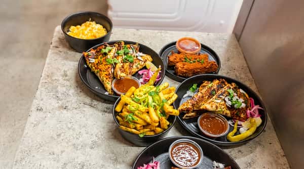 Grilled chicken meal with fries and sides