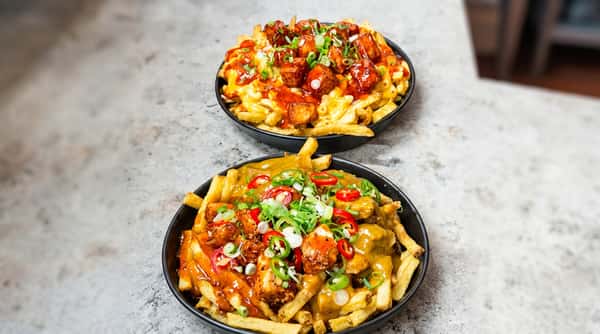 Loaded chicken fries topped with cheese and sauces