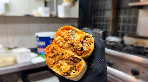 Cheesy beef burrito with fries and sauces