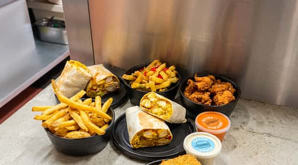 Chicken wraps served with crispy fries and dipping sauces
