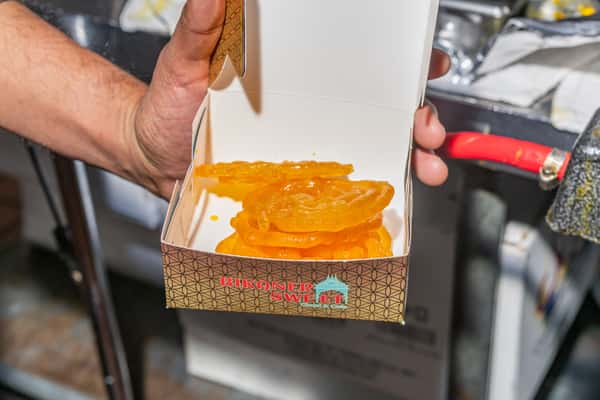 Chef holding a to-go box with a shareable appetizer