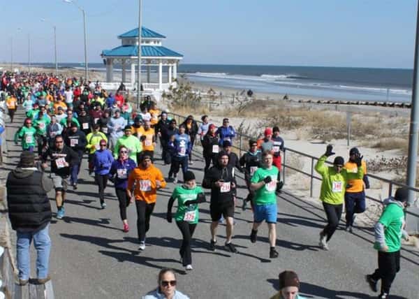People running a marathon alongside the shore