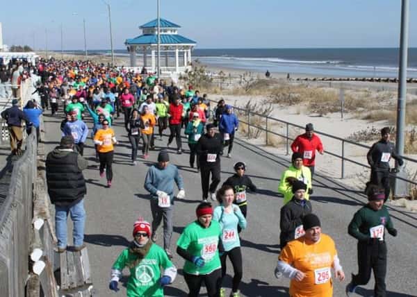 People running a marathon alongside the shore
