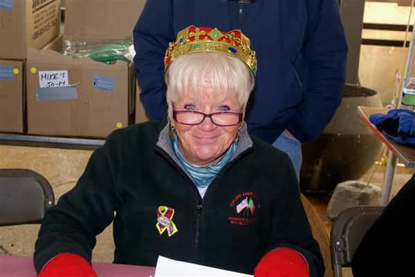 Lady wearing a crown taking a photo