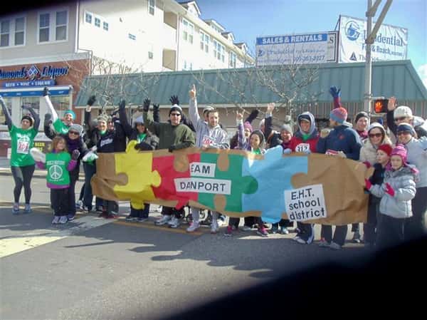 People holding autism awareness banner