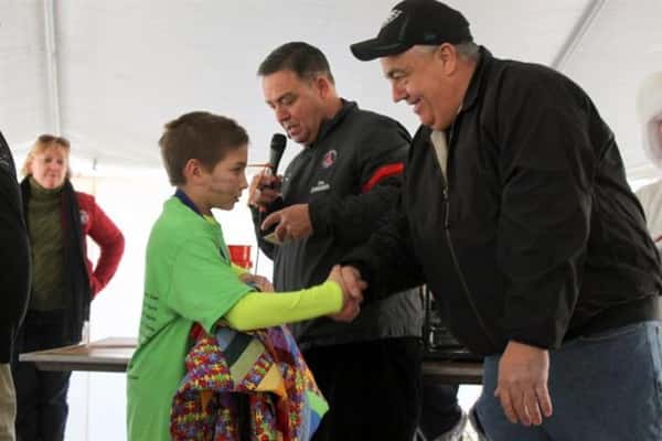 Boy shaking hands with a man