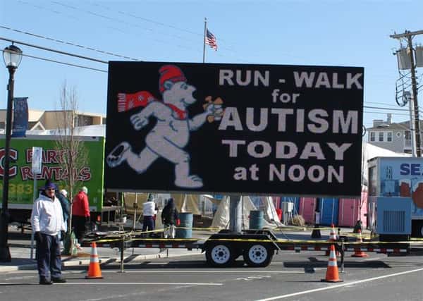 Polar Bear Run-walk for autism today at noon sign on road.
