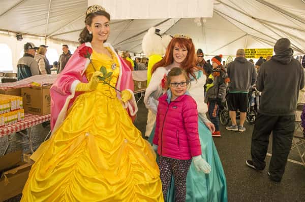 someone dressed up as belle from beauty and the beast with a kid