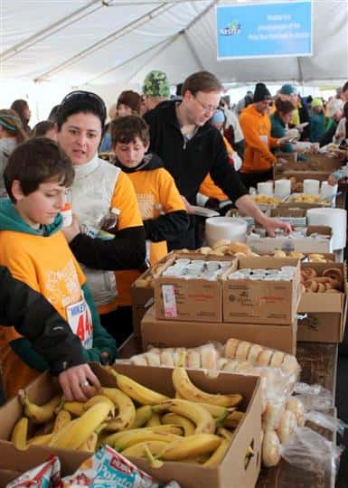 People taking fruit and bread