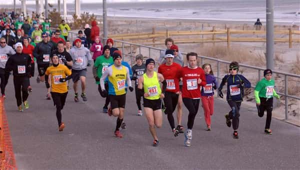 People doing the polar bear marathon alongside the shore