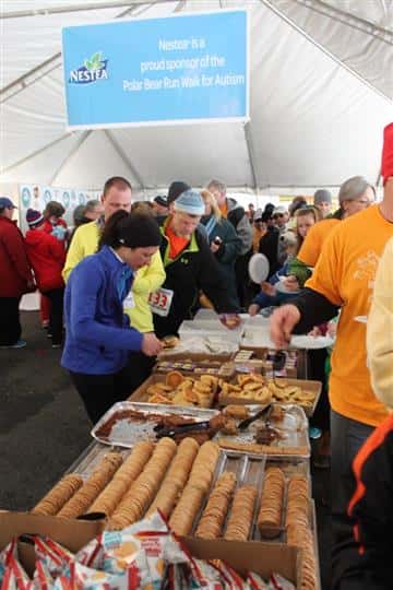 People taking food under a tent