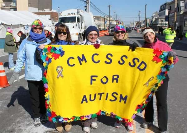 CMCSSSD for autism banner being held up by supporters.