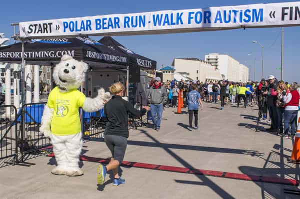 polar bear mascot high fiving a runner