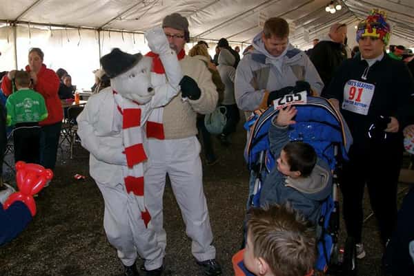 Person in polar bear costume air high fiving toddler