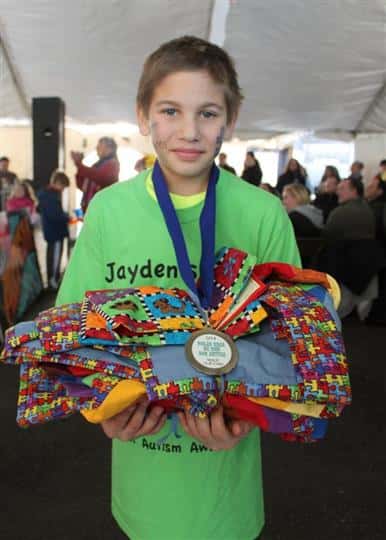 Boy holding autism awareness items