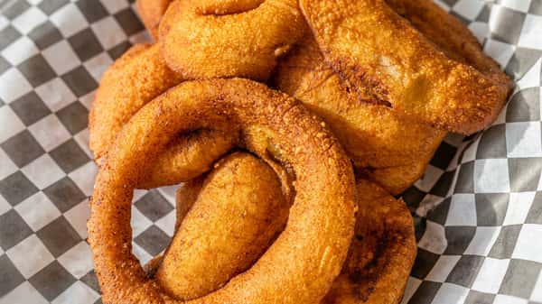 Deep-fried churros on checkered wax paper.