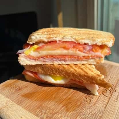 Grilled ham and cheese panini, cut in half and stacked