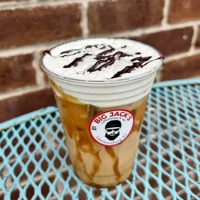 Iced caramel latte with whipped cream and caramel drizzle
