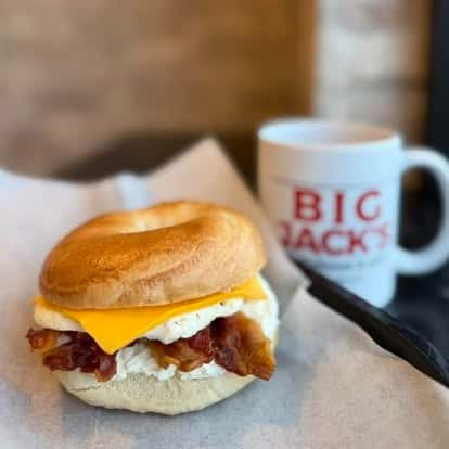 Bacon, egg, and cheese biscuit sandwich with a Big Jack's coffee mug