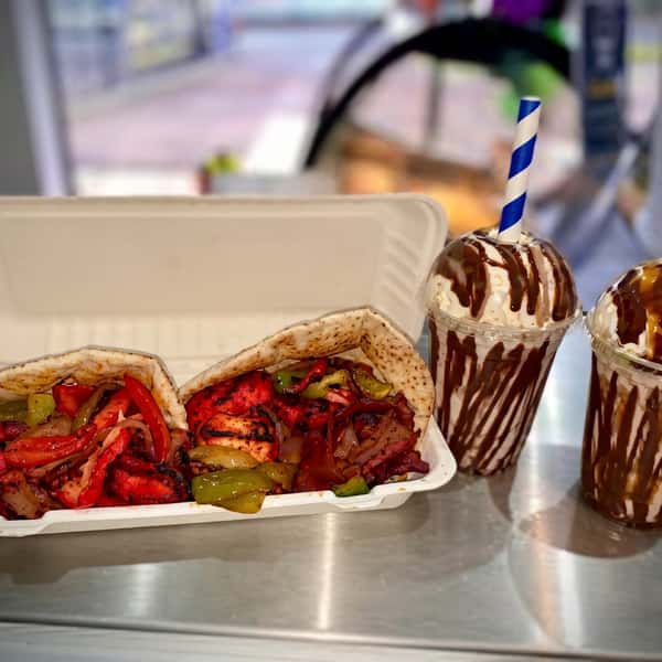 Grilled chicken kebabs with peppers and onions in flatbread served with chocolate milkshakes
