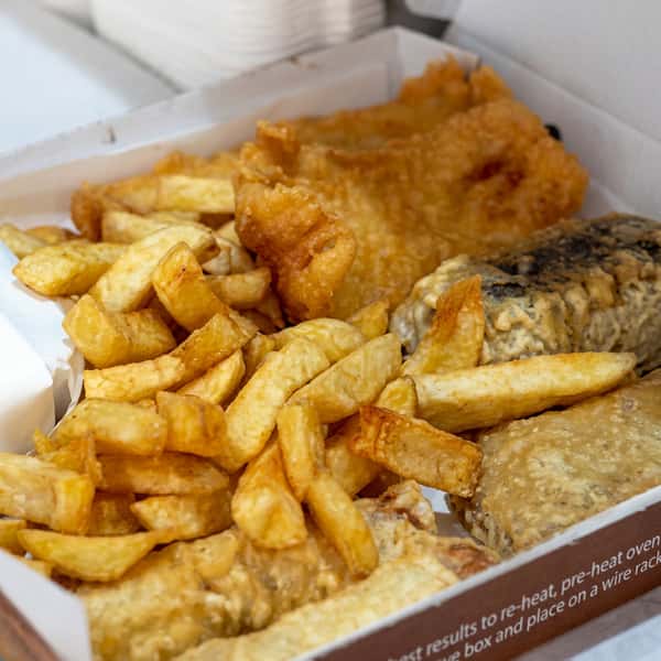 Traditional fish and chips takeaway box with crispy battered fish and thick-cut golden chips