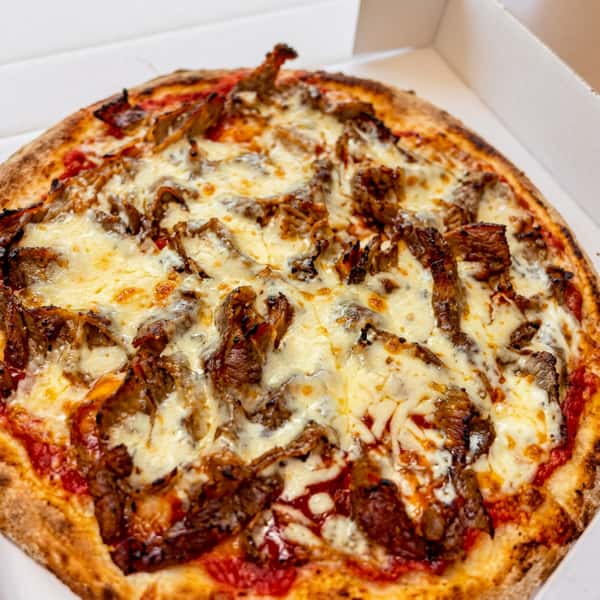 Freshly baked meat pizza topped with melted cheese and a golden crisp crust