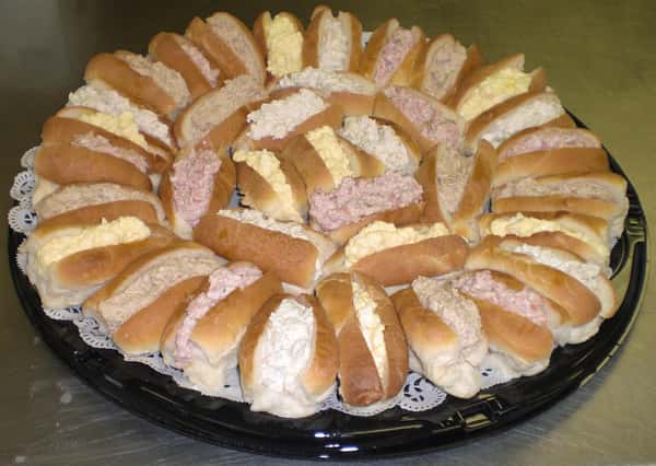 Platter with sandwiches filled with tuna salad, chicken salad and crabmeat salad