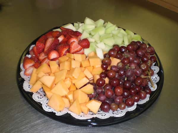 Fruit platter with canteloupe, red grapes, strawberries and honey dew