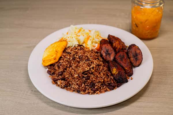 Gallo pinto is a traditional breakfast dish made from fried rice mixed with beans, served with Fried ripe plantain, fried cheese and cabbage salad.