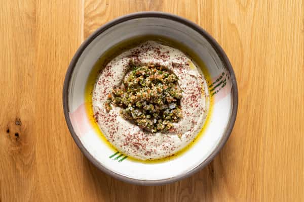 A plate with pesto and hummus