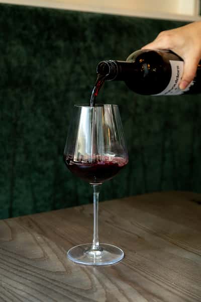 pouring a glass of red wine