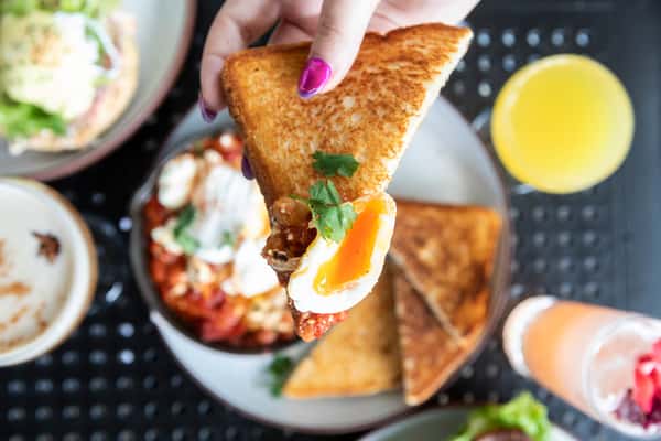 Toast with an over easy egg on a patio