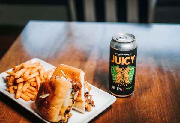 Sandwich paired with a local beer and fresh french fries